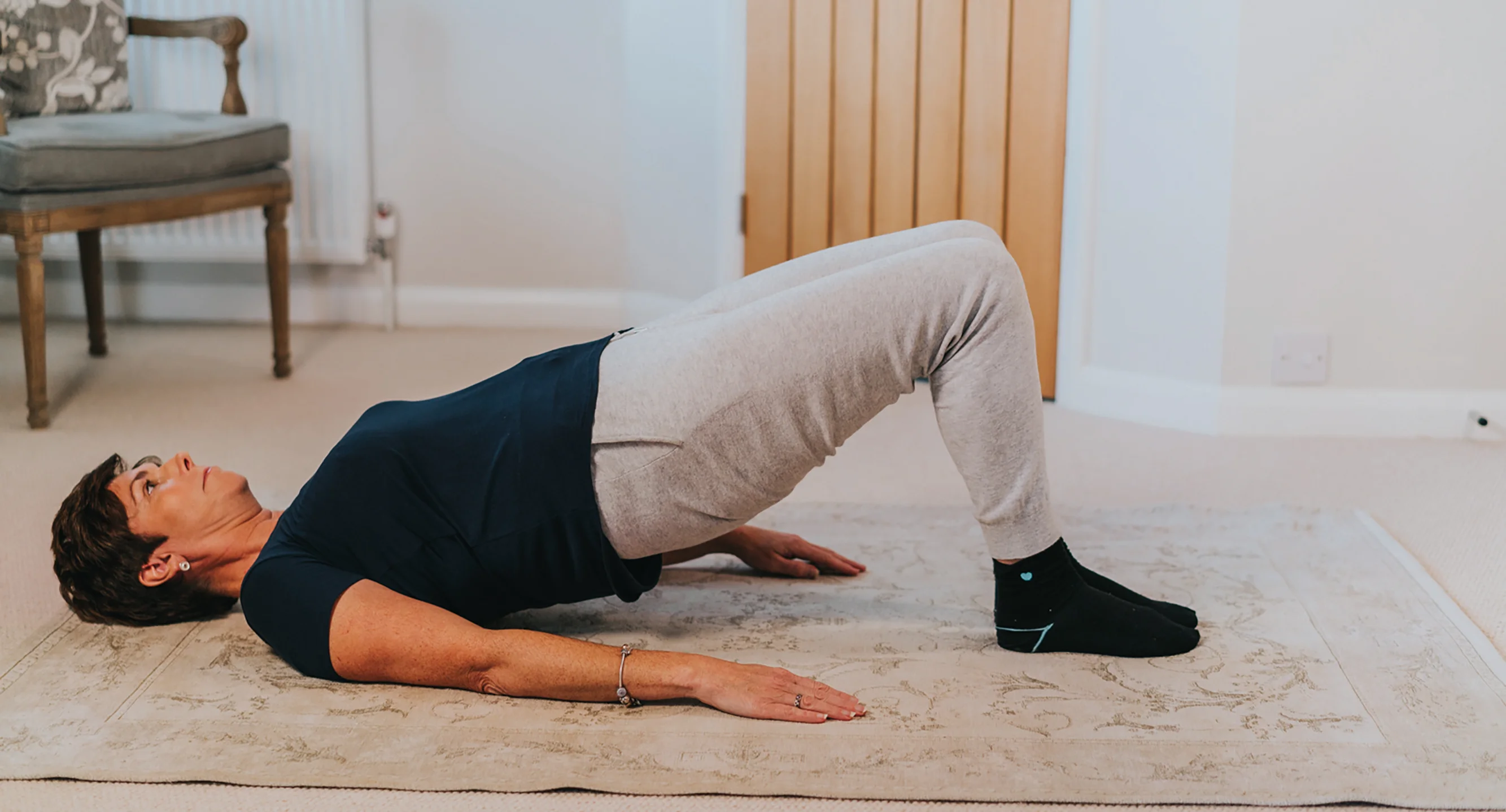 a woman doing an exercise on the floor